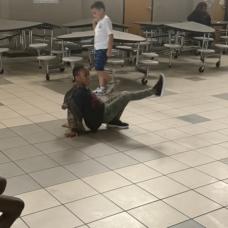 Student breakdancing at a dance party