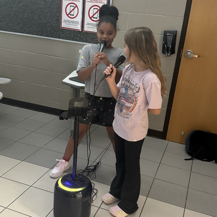 Two students singing karaoke