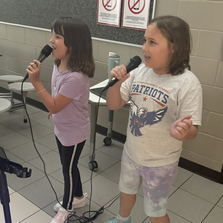 Two students singing karaoke