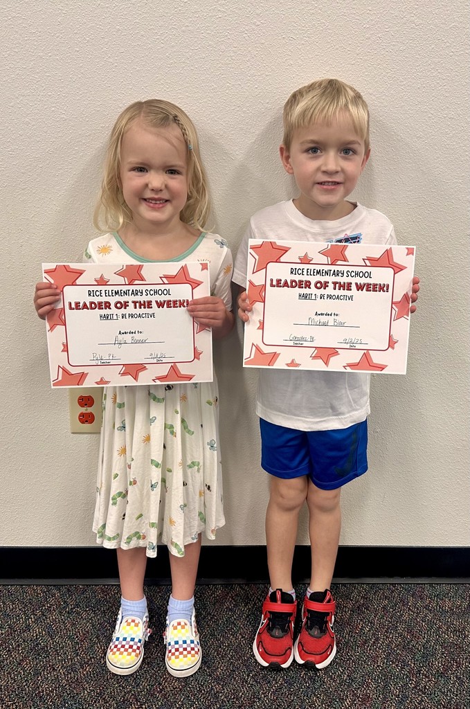 a boy and a girl holding certificates