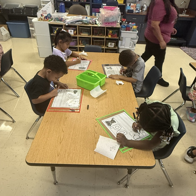pre-K students working in stations