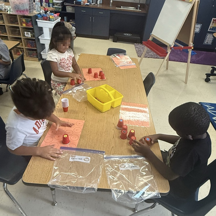 Pre-K students working at stations