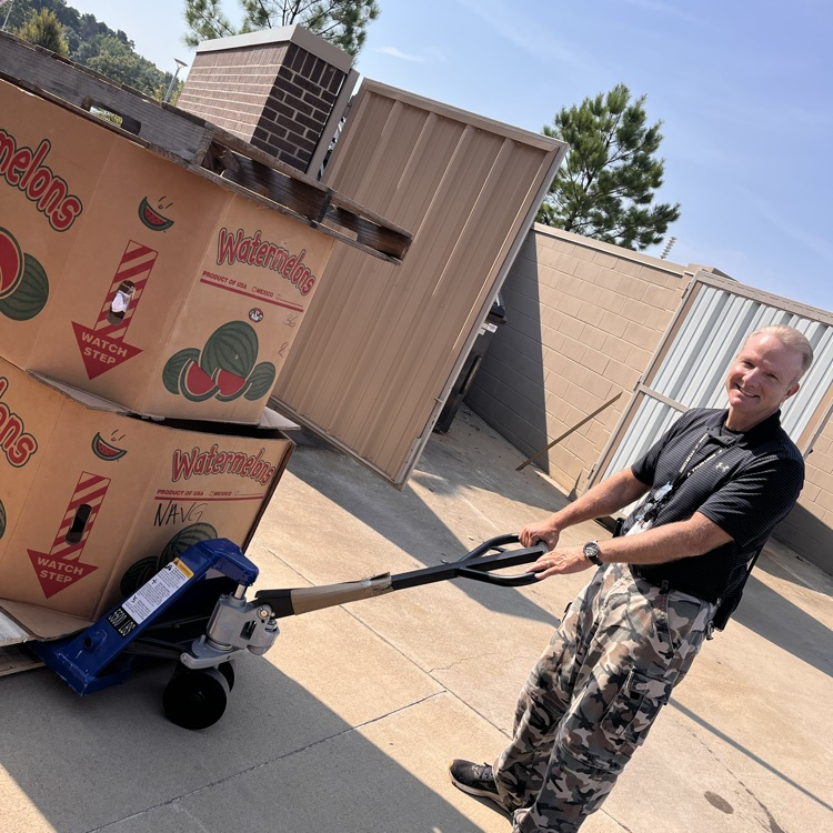 man pulling cart of canned goods