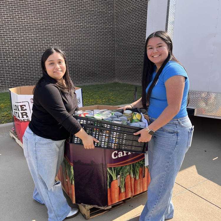 girls loading canned goods into boxes