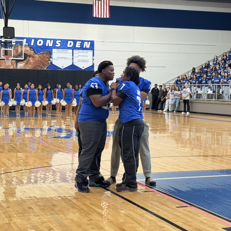 football players speaking to the crowd