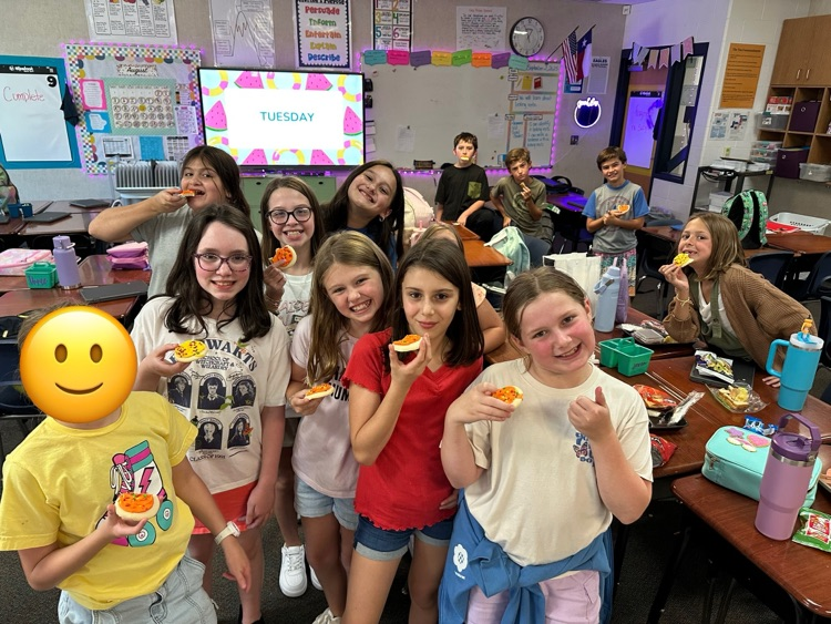 A group of kids in a classroom .