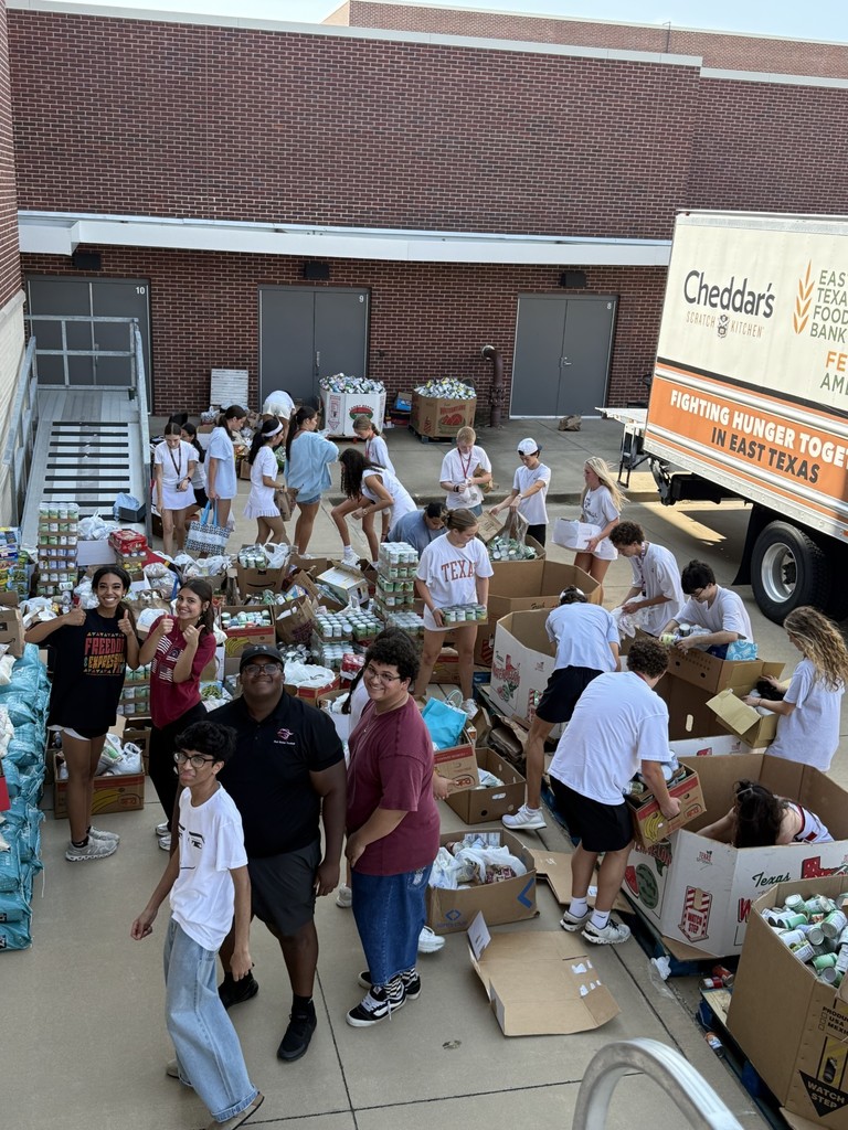 Tyler Legacy students loading food from the food drive into trucks for donation