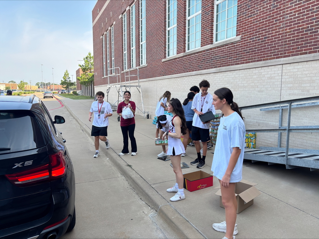 Tyler Legacy students loading food from the food drive into trucks for donation