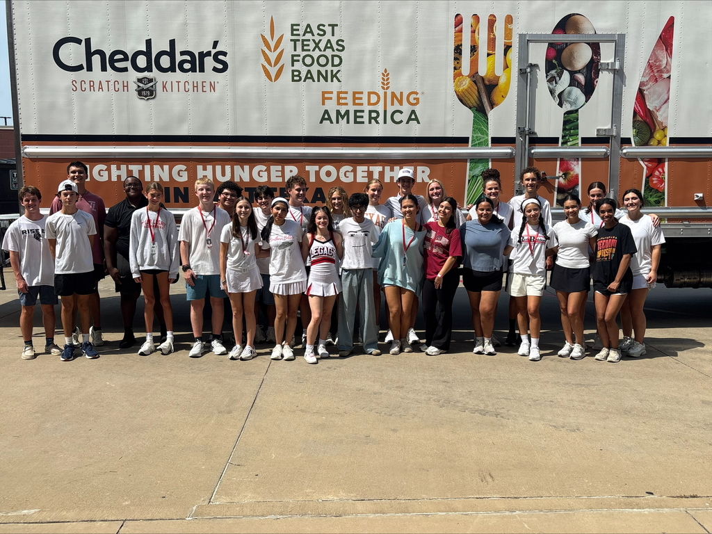 Tyler Legacy students loading food from the food drive into trucks for donation