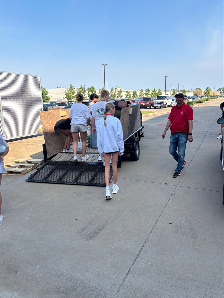 Tyler Legacy students loading food from the food drive into trucks for donation