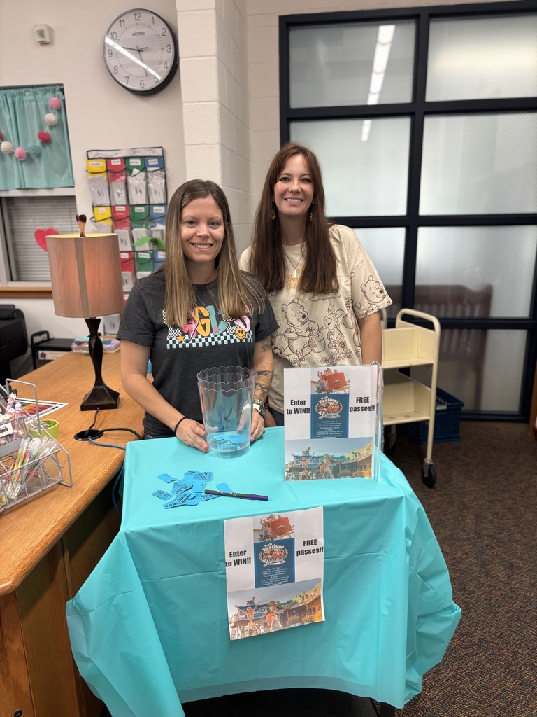 PTA moms standing by raffle area.