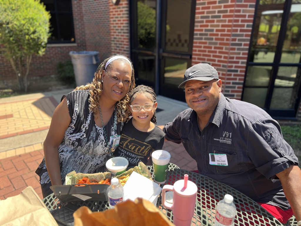 grandparents smiling with granddaughter