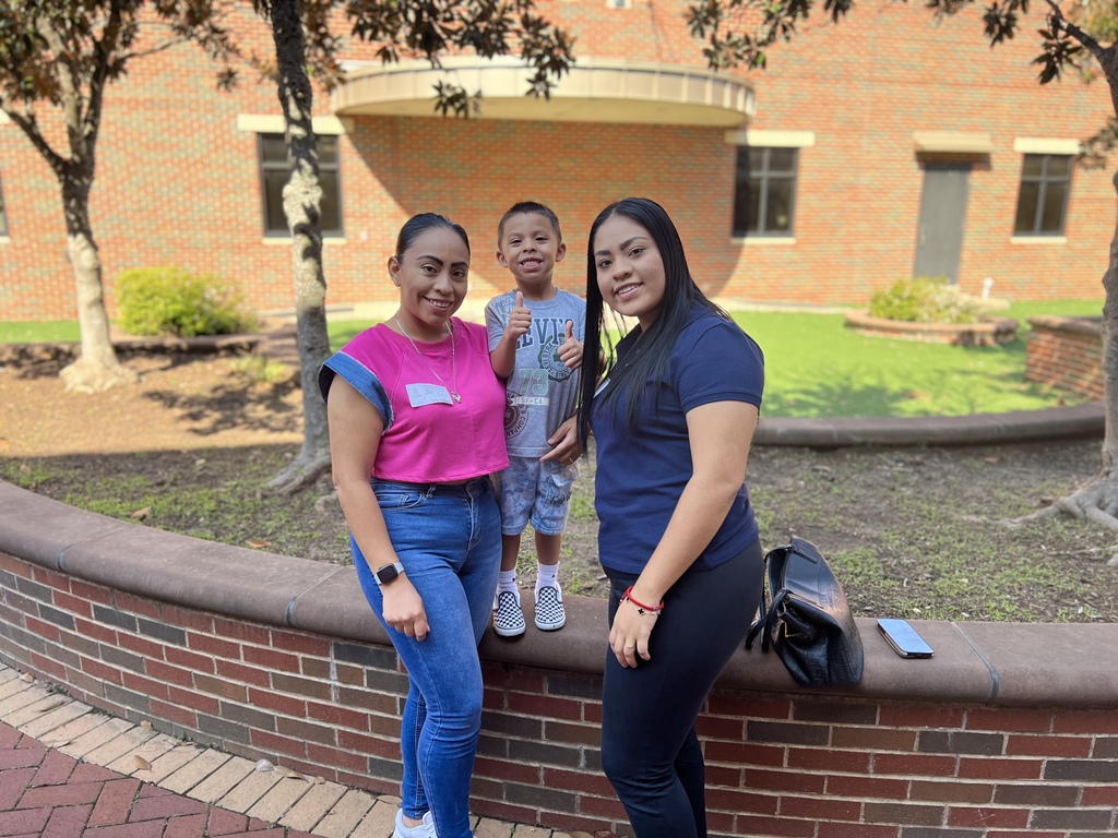 mom and daughter smiling with son