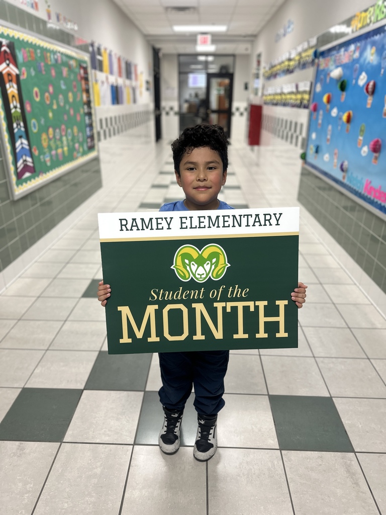 Child holding sign that says Student of the Month