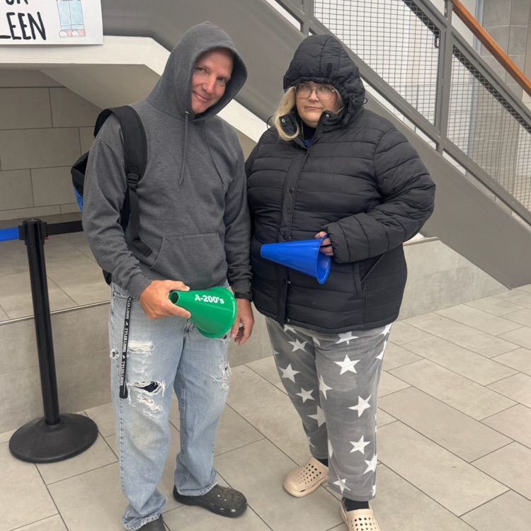 two adults dressed as students 