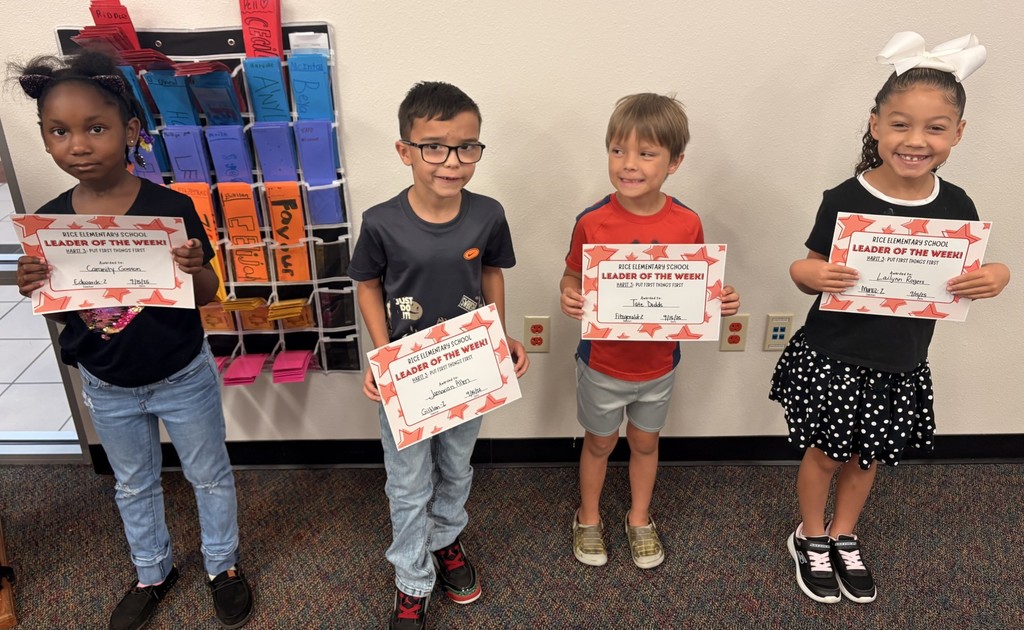 four students holding up a certificate