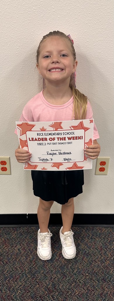 a student holding up a certificate