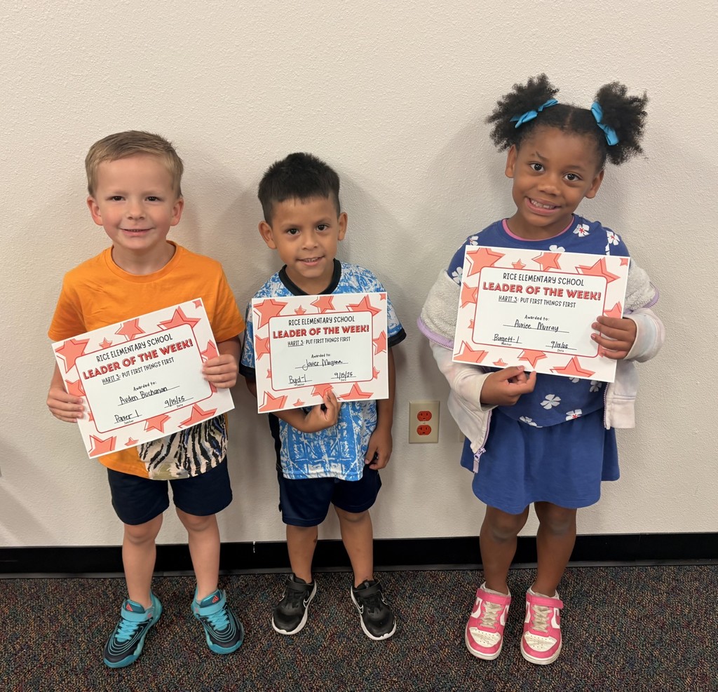 three students holding up a certificate