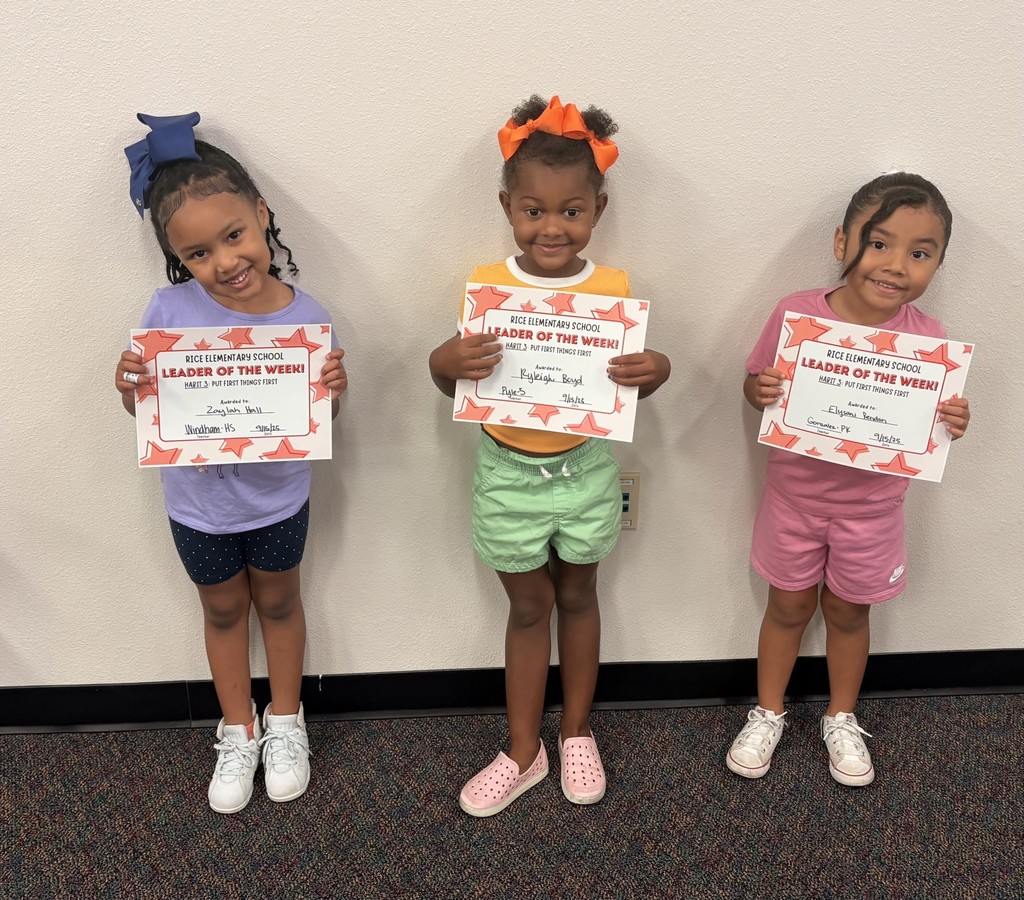 three students holding up a certificate