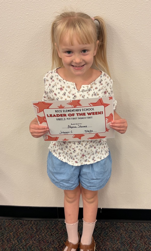 a student holding up a certificate
