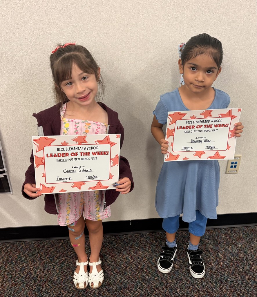 two students holding up a certificate