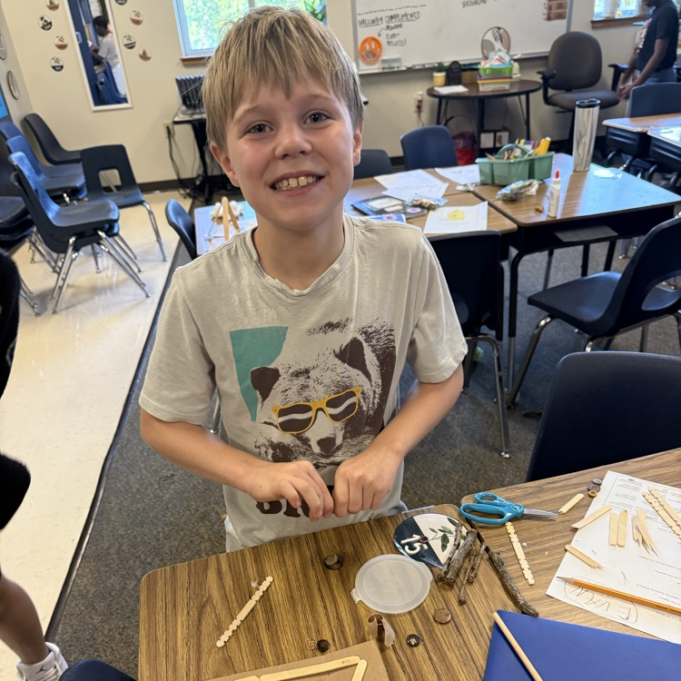 student working on STEM project Native American homes