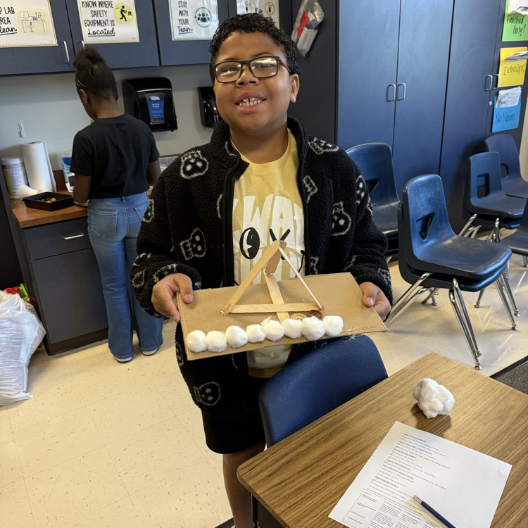 student working on STEM project Native American homes