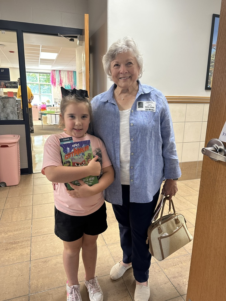 child with grand friends after shopping at the book fair