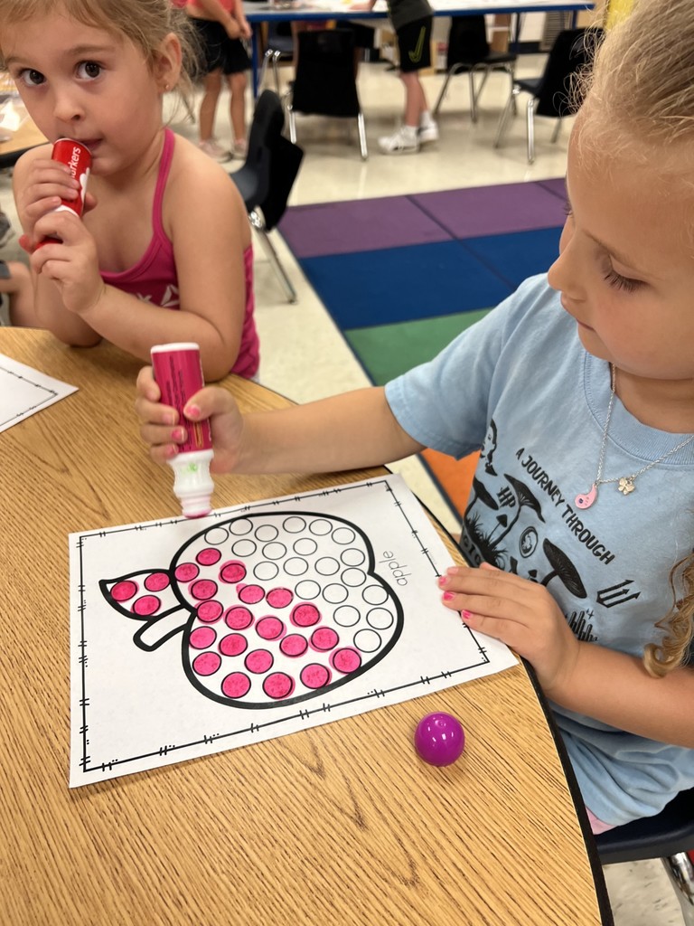 Student decorating an apple page.