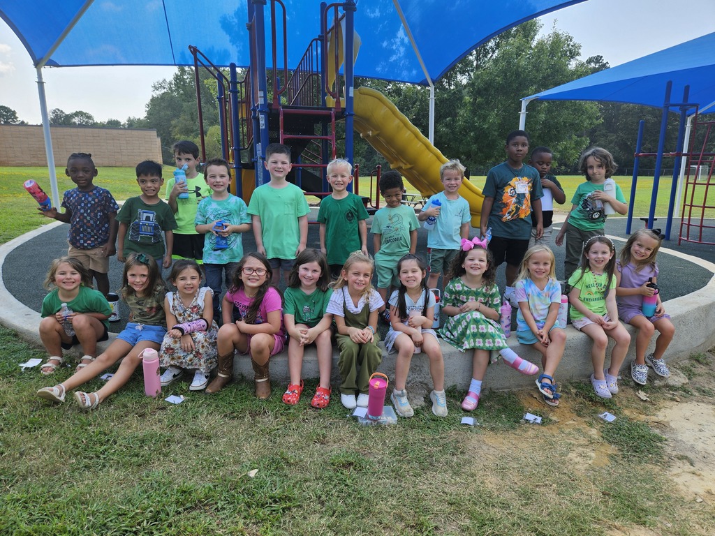 A group of students wearing green at recess. 