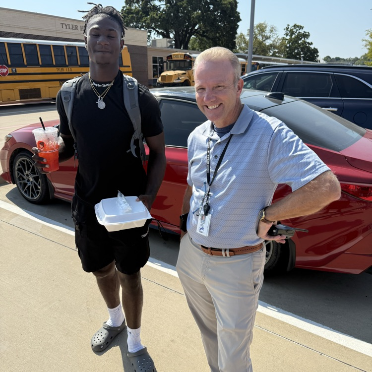 two men who were getting food from the food truck