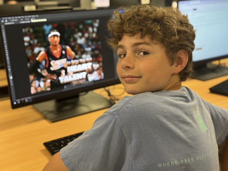 A student next to a computer.