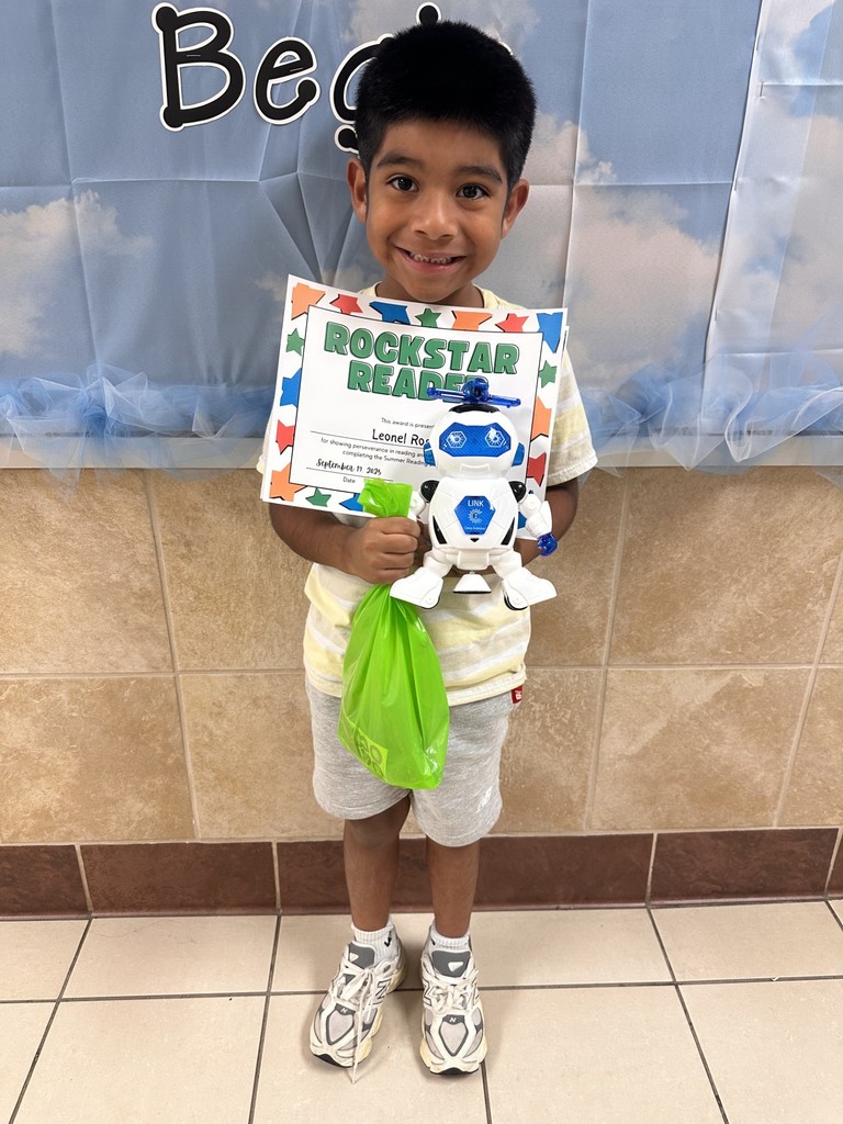 student holding a certificate and prizes