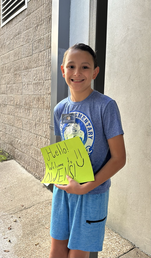 one boy holding a sign that says “hello"