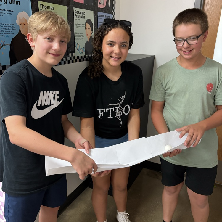 students racing a ping pong ball 