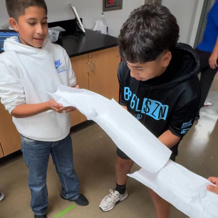 students racing a ping pong ball 
