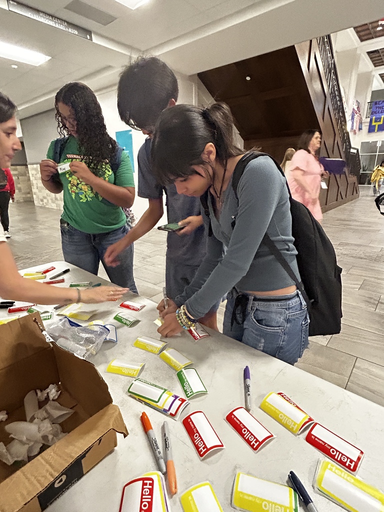 Students writing name tags for Hello Week