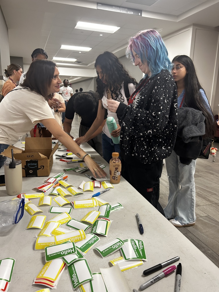 Students writing name tags for Hello Week