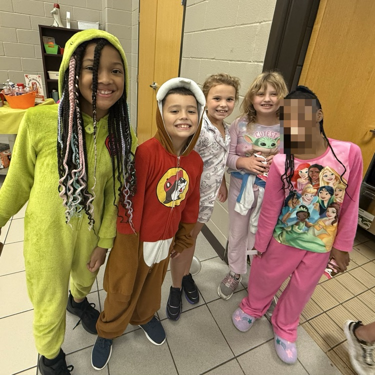 Students dressed up in pajamas, standing in the lunch line