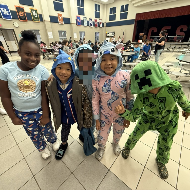 Students dressed up in pajamas, standing in the cafeteria
