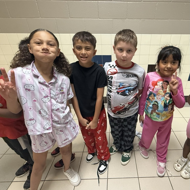 Students dressed up in pajamas, lined up in the hallway