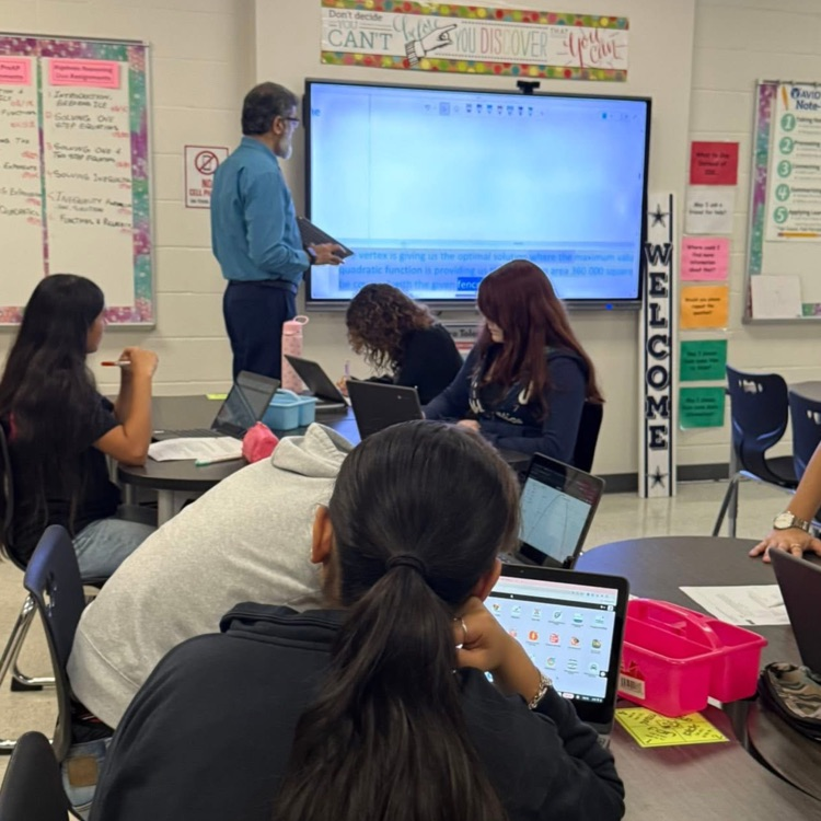 teacher at board teaching