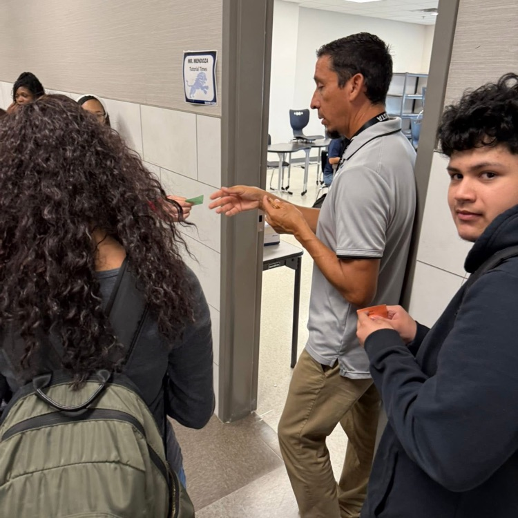 teacher quizzing students before entering class