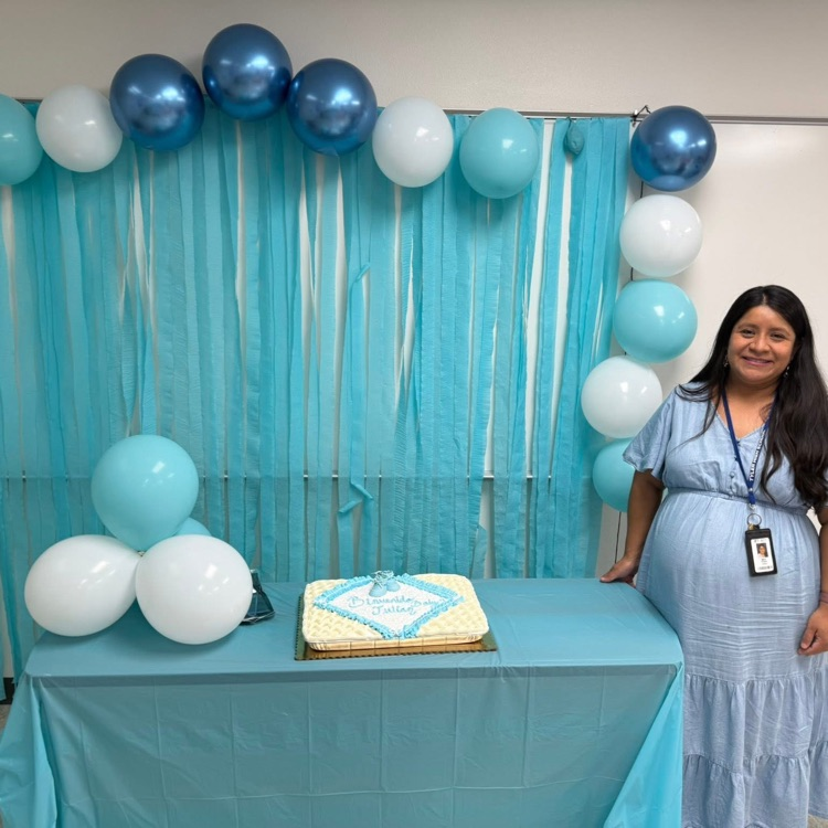 pregnant teacher at table with cake