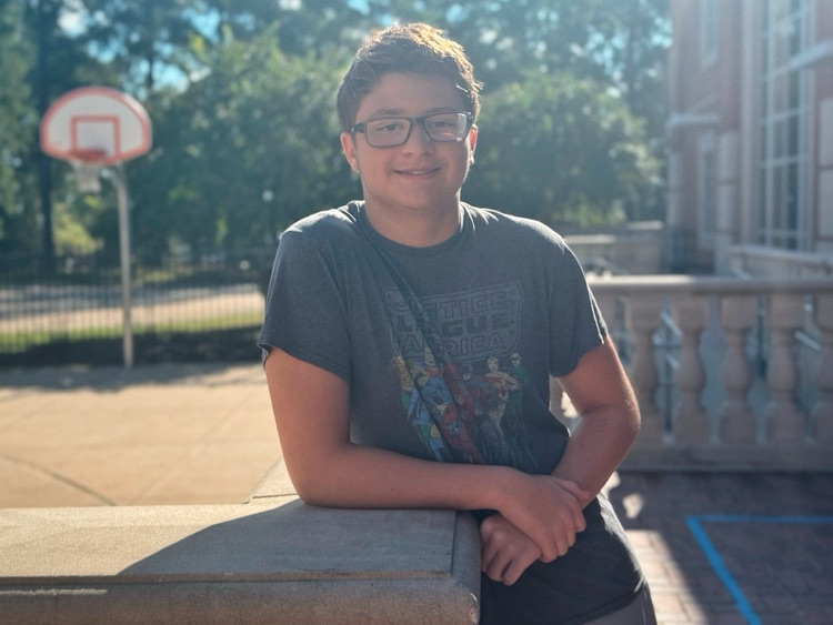 A student standing in the courtyard.