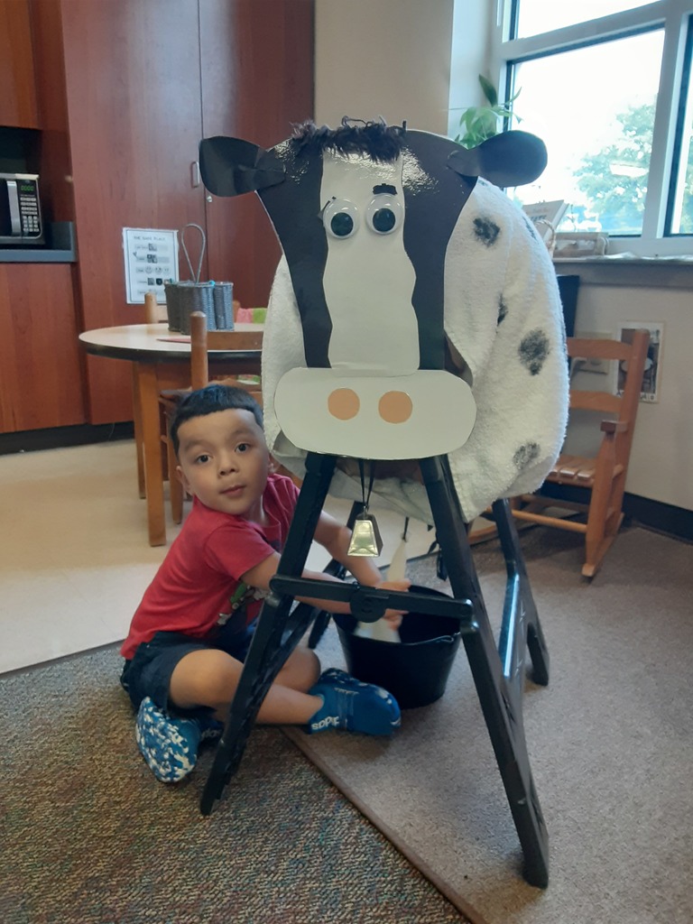 Child milking a pretend cow