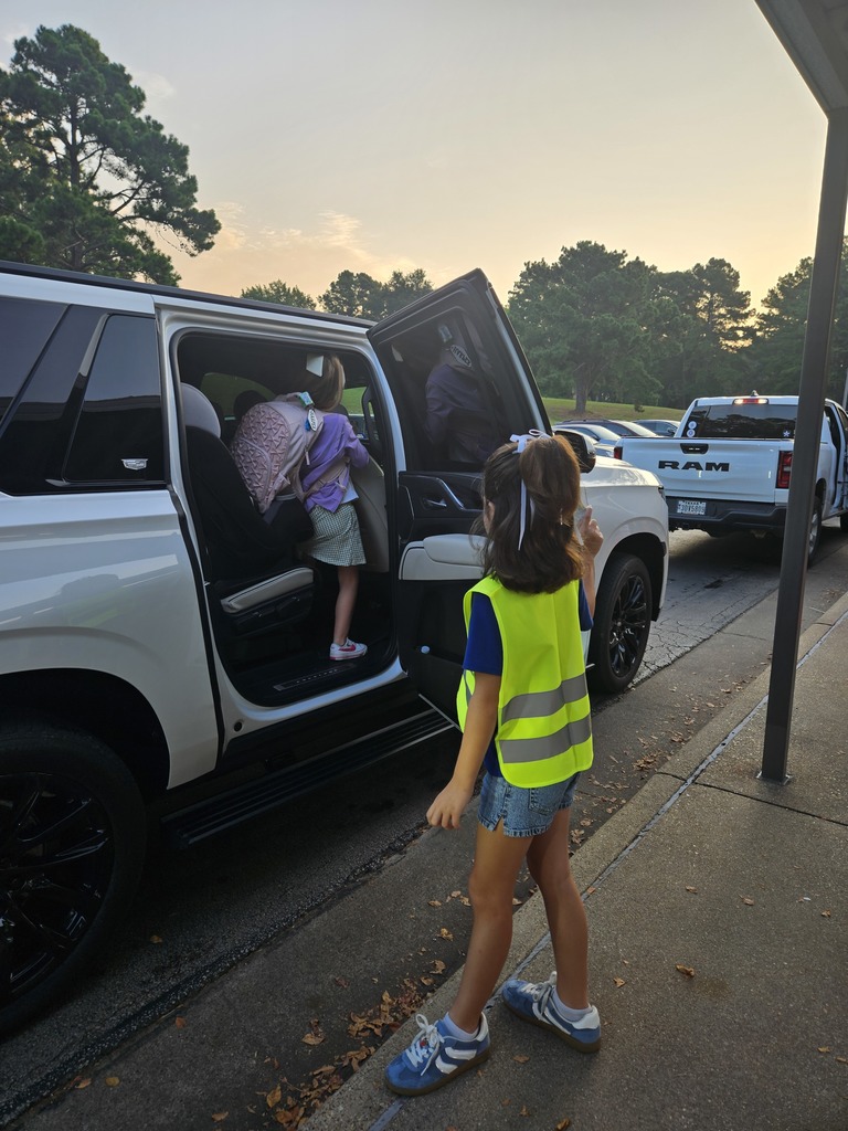 Safety team helping a student get out of the car.