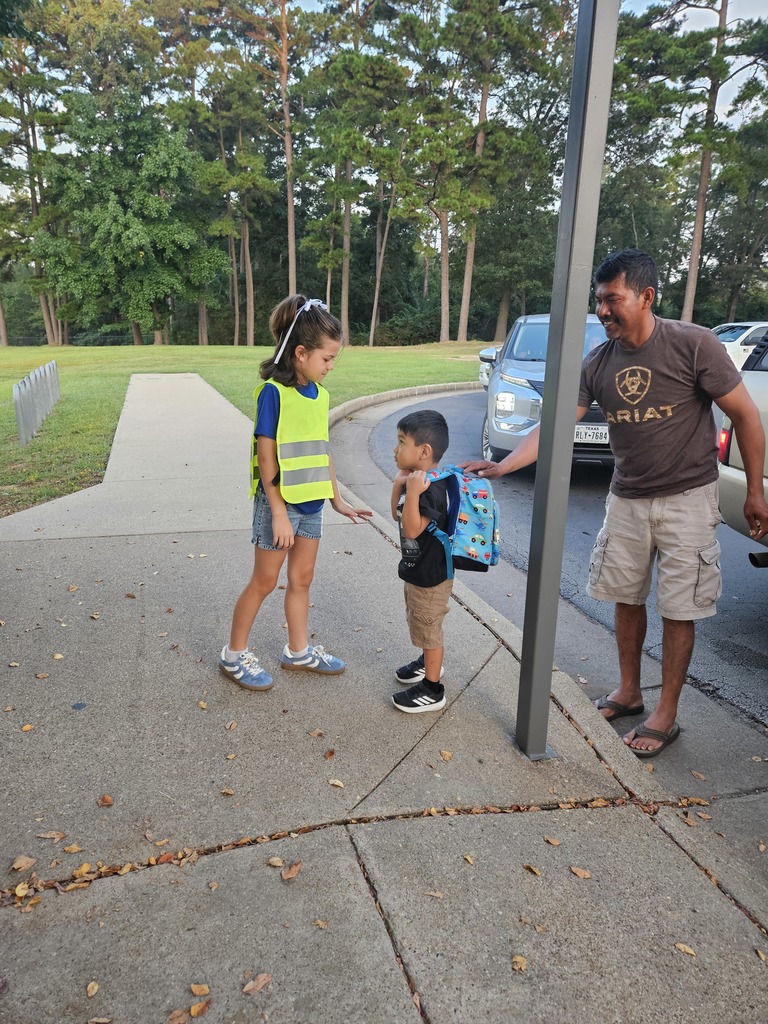 Safety team helping a student get out of the car.