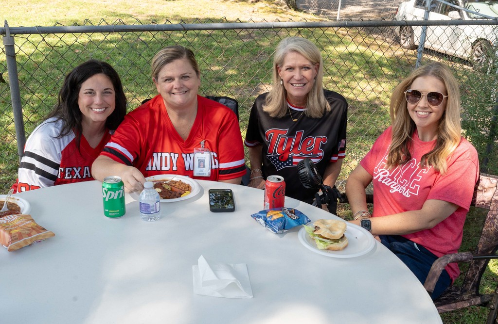 Tyler ISD Principals smile around table during National Principals Month celebration.