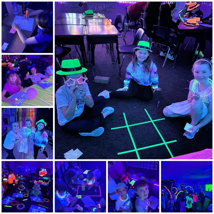 Third grade students participating in “glow day” doing both math and reading activities.